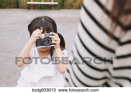 Young girl with camera View Large Photo Image Stock Image - Young girl with camera. Fotosearch