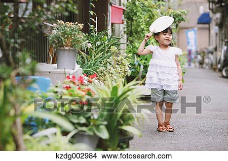 Young girl with paper fan View Large Photo Image Picture - Young girl with paper fan. Fotosearch