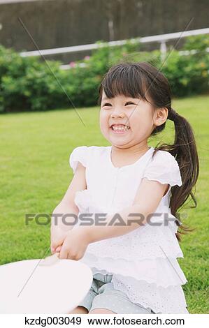 Stock Photo - Young girl with paper fan. Fotosearch