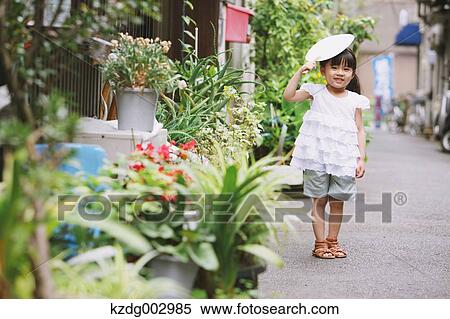 Stock Photography - Young girl with paper fan. Fotosearch
