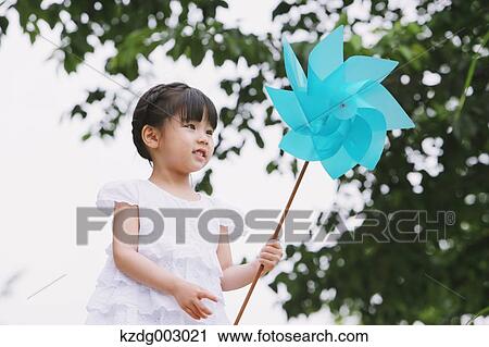 Young girl with pinwheel View Large Photo Image Stock Image - Young girl with pinwheel. Fotosearch