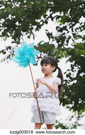 Young girl with pinwheel View Large Photo Image Stock Photo - Young girl with pinwheel. Fotosearch