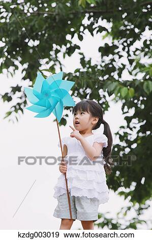 Young girl with pinwheel View Large Photo Image Stock Photo - Young girl with pinwheel. Fotosearch