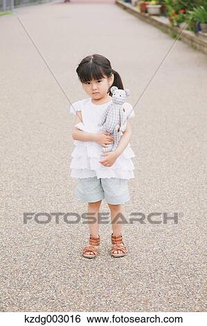 Stock Photograph - Young girl with teddy bear. Fotosearch