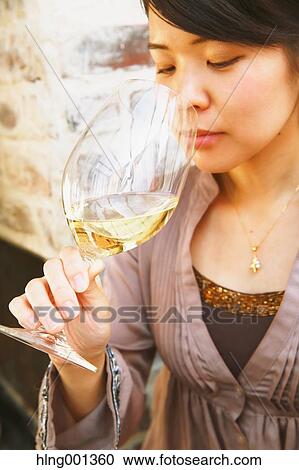 Young Japanese woman tasting wine in a fashionable bar View Large Photo Image Stock Image - Young Japanese woman tasting wine in a fashionable bar. Fotosearch