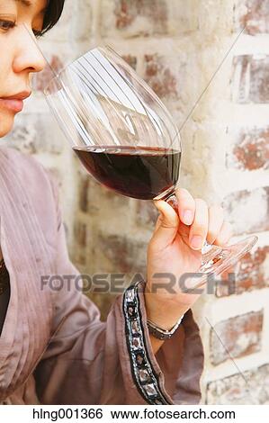 Young Japanese woman tasting wine in a fashionable bar View Large Photo Image Stock Photograph - Young Japanese woman tasting wine in a fashionable bar. Fotosearch