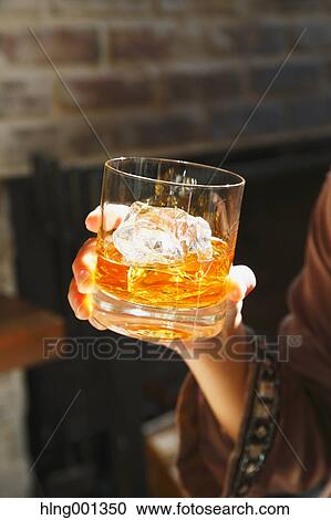 Young Japanese woman with glass of whiskey in a fashionable bar View Large Photo Image Stock Image - Young Japanese woman with glass of whiskey in a fashionable bar. Fotosearch