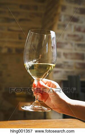 Stock Photo - Young Japanese woman with glass of wine in a fashionable bar. Fotosearch