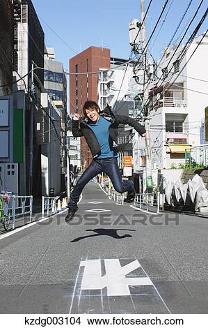 Young man jumping in an alley View Large Photo Image Picture - Young man jumping in an alley. Fotosearch