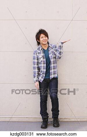 Stock Image - Young man looking at camera. Fotosearch