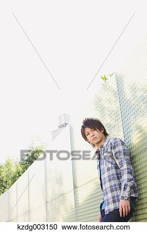 Young man looking at camera View Large Photo Image Stock Image - Young man looking at camera. Fotosearch