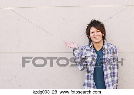 Stock Photo - Young man looking at camera. Fotosearch