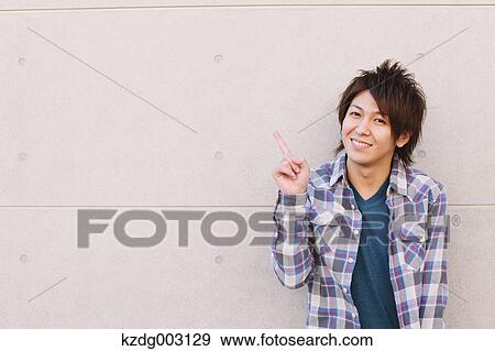 Young man looking at camera View Large Photo Image Stock Photo - Young man looking at camera. Fotosearch