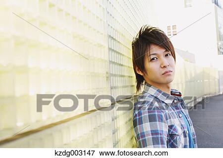 Stock Photo - Young man looking at camera. Fotosearch