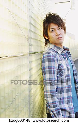 Stock Photo - Young man looking at camera. Fotosearch