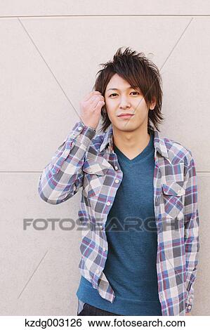 Young man looking at camera View Large Photo Image Stock Photograph - Young man looking at camera. Fotosearch