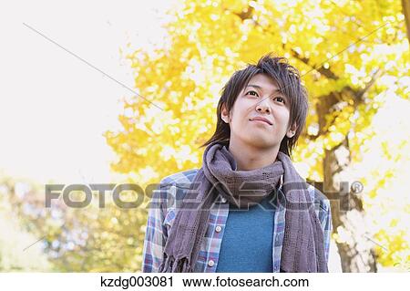 Stock Image - Young man looking away. Fotosearch