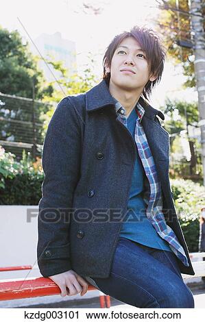 Stock Image - Young man looking away. Fotosearch