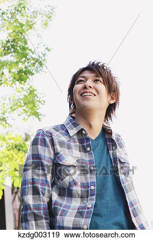 Young man looking away View Large Photo Image Stock Photo - Young man looking away. Fotosearch