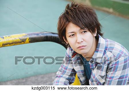 Stock Photography - Young man looking away. Fotosearch