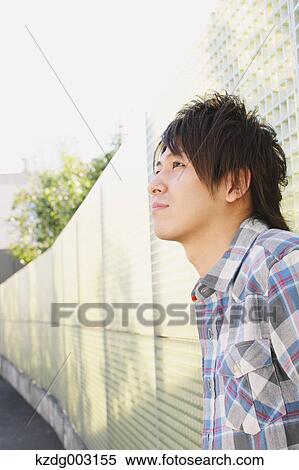 Stock Photography - Young man looking away. Fotosearch