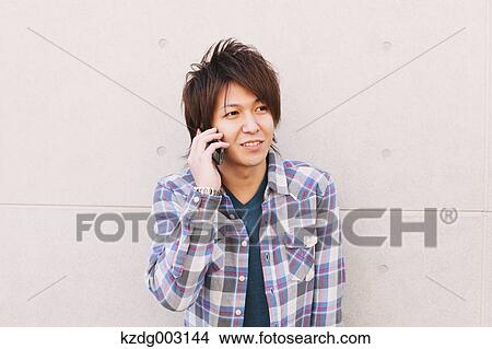 Young man on the phone View Large Photo Image Picture - Young man on the phone. Fotosearch