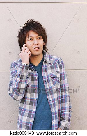 Young man on the phone View Large Photo Image Stock Image - Young man on the phone. Fotosearch