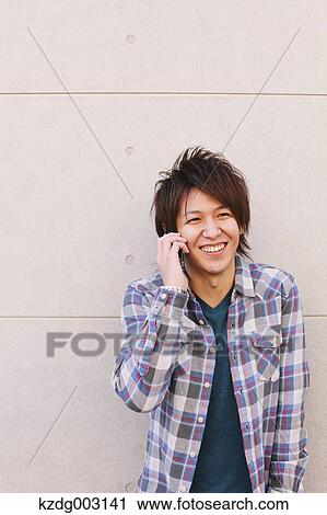 Young man on the phone View Large Photo Image Stock Image - Young man on the phone. Fotosearch