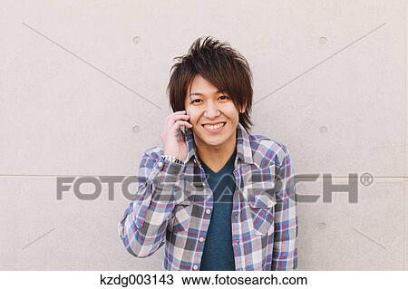 Young man on the phone View Large Photo Image Stock Image - Young man on the phone. Fotosearch