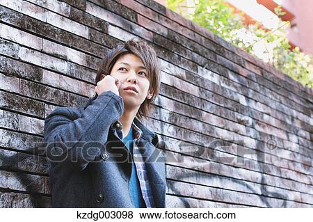 Young man on the phone View Large Photo Image Stock Photo - Young man on the phone. Fotosearch
