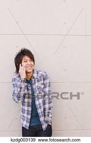 Young man on the phone View Large Photo Image Stock Photo - Young man on the phone. Fotosearch