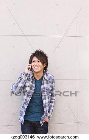 Stock Photograph - Young man on the phone. Fotosearch