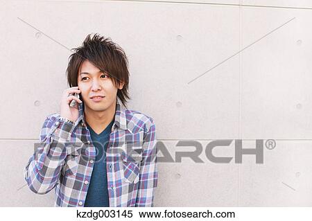 Stock Photography - Young man on the phone. Fotosearch