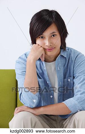 Young man on the sofa View Large Photo Image Stock Image - Young man on the sofa. Fotosearch