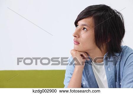 Stock Image - Young man on the sofa. Fotosearch