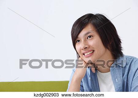Young man on the sofa View Large Photo Image Stock Image - Young man on the sofa. Fotosearch