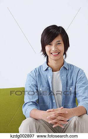 Young man on the sofa View Large Photo Image Stock Photo - Young man on the sofa. Fotosearch