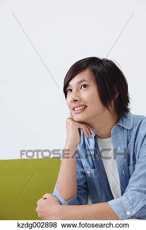 Young man on the sofa View Large Photo Image Stock Photo - Young man on the sofa. Fotosearch