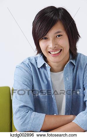 Stock Photograph - Young man on the sofa. Fotosearch
