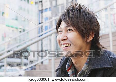 Young man sitting on the stairs View Large Photo Image Stock Image - Young man sitting on the stairs. Fotosearch