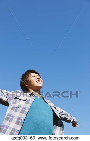 Young man spreading arms View Large Photo Image Stock Image - Young man spreading arms. Fotosearch
