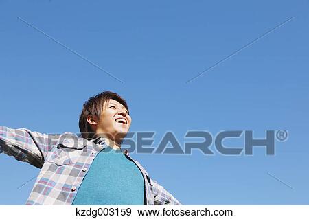 Young man spreading arms View Large Photo Image Stock Photo - Young man spreading arms. Fotosearch
