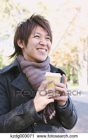 Stock Image - Young man with coffee. Fotosearch
