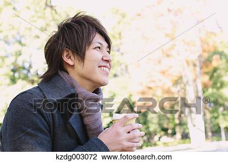 Stock Image - Young man with coffee. Fotosearch