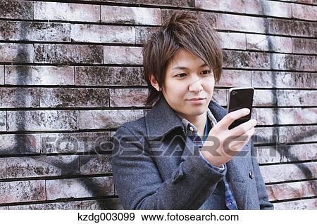 Stock Photo - Young man with Smartphone. Fotosearch
