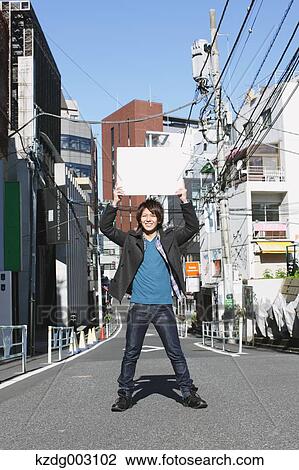 Young man with white board View Large Photo Image Stock Image - Young man with white board. Fotosearch