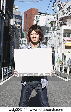 Young man with whiteboard View Large Photo Image Stock Image - Young man with whiteboard. Fotosearch