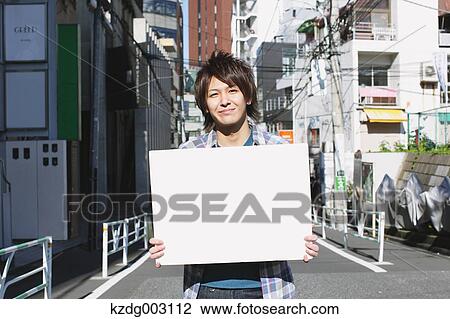 Young man with whiteboard View Large Photo Image Stock Image - Young man with whiteboard. Fotosearch