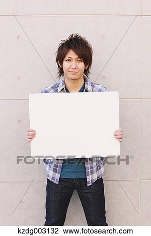 Young man with whiteboard View Large Photo Image Stock Image - Young man with whiteboard. Fotosearch