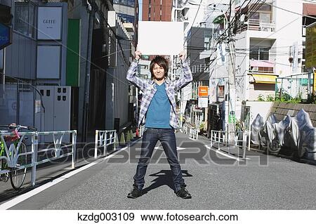 Young man with whiteboard View Large Photo Image Stock Photo - Young man with whiteboard. Fotosearch